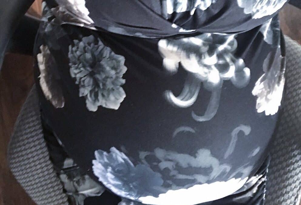 Pregnant belly in floral dress from the perspective of Suzi looking down at it, 38 weeks, 4cm dilated and 80%