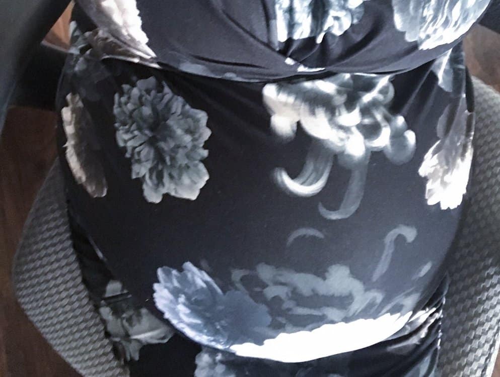 Pregnant belly in floral dress from the perspective of Suzi looking down at it, 38 weeks, 4cm dilated and 80%