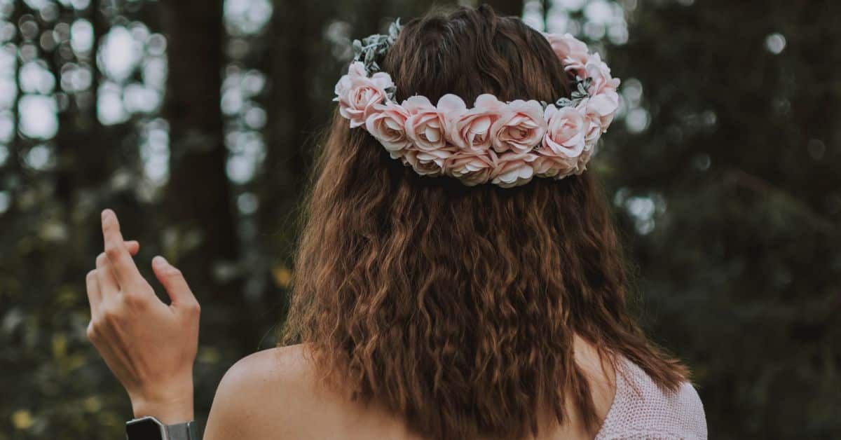 Back of a woman's head who is wearing a floral crown