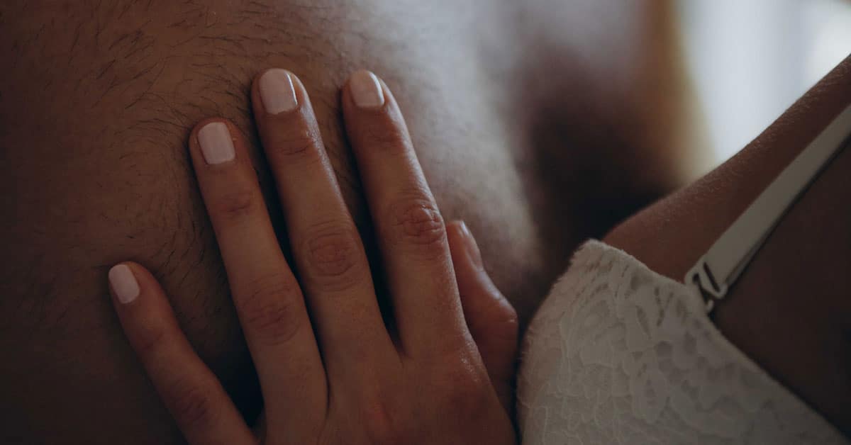 A woman in bra rests her hand on a man's bare chest, Why a Woman Might Not Be Able to Orgasm