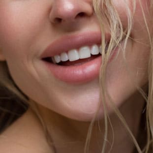Close up of a beautiful woman's smile and full lips
