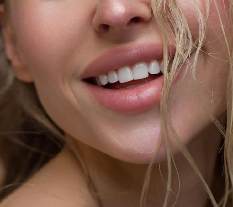 Close up of a woman with beautiful smile and full lips, dermal and lip plumping fillers
