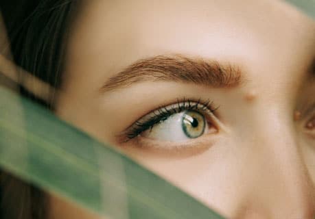 Closeup of a woman with a beautiful full eyebrow looking off to the side
