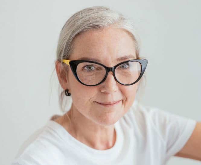 Portrait of a grey-haired woman in fashion glasses