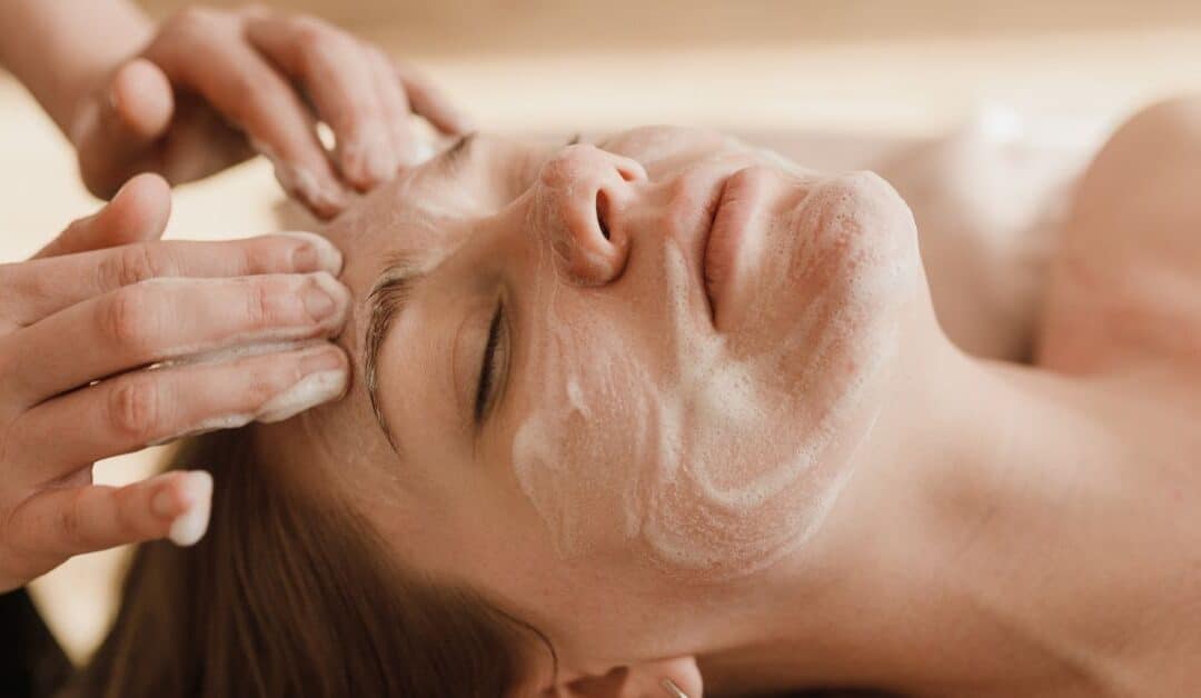 A woman receives a cleansing facial at the spa