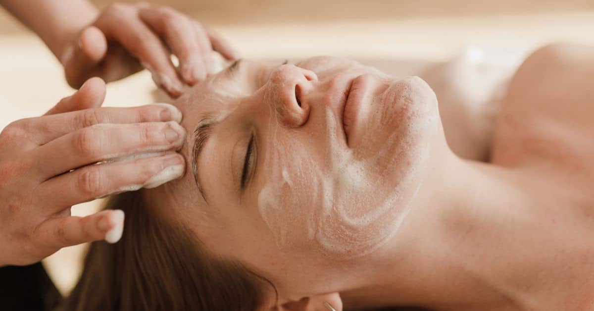 A woman receives a cleansing facial at the spa