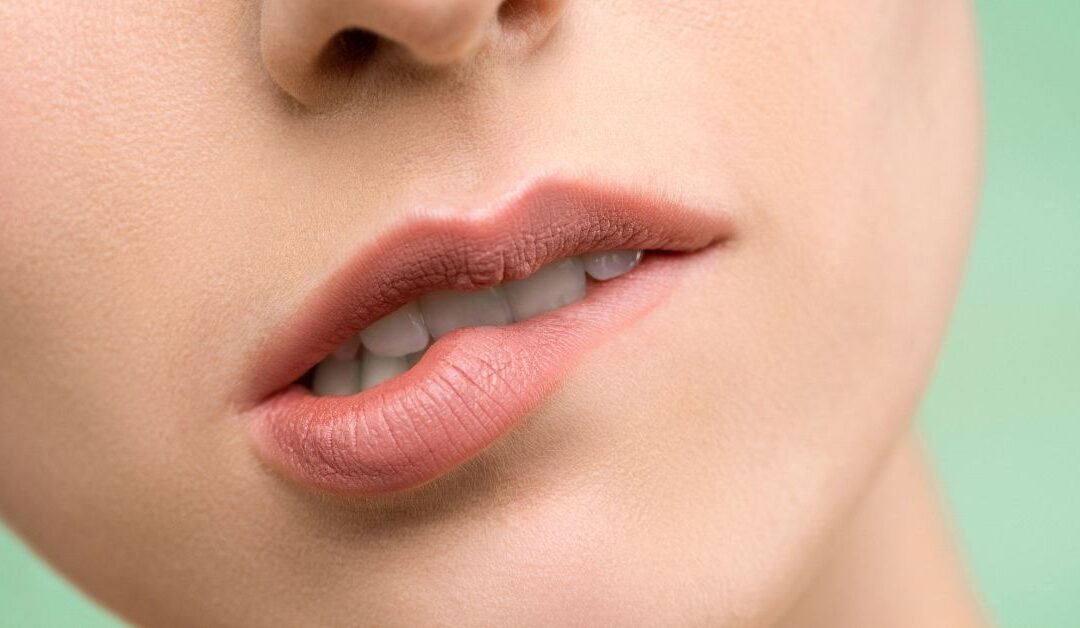 Closeup of a woman biting her lip